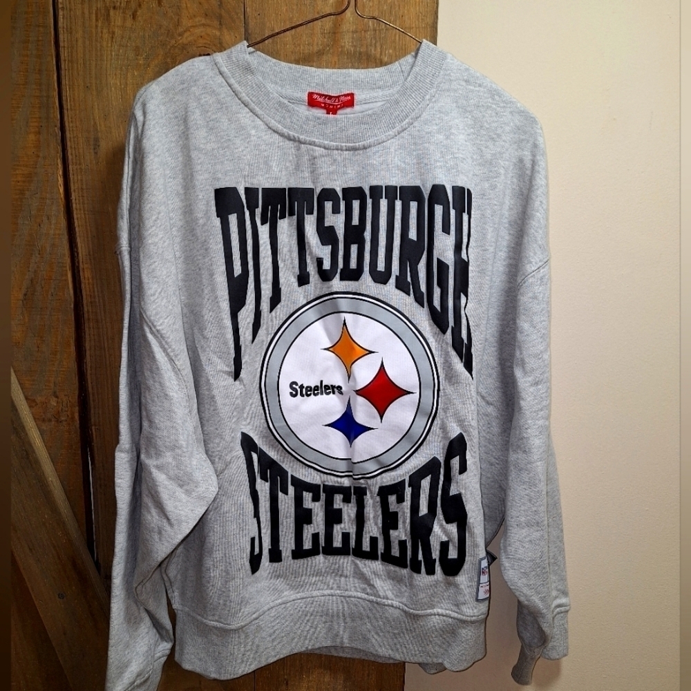A Mitchell and Ness official NFL Pittsburg Steelers sweatshirt in women's large.